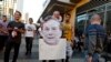 A Los Angeles Clippers fan holds a cut out picture of owner Donald Sterling as the fan arrives to attend the Clippers playoff game five against the Golden State Warriors at the Staples Center in Los Angeles, California, April 29, 2014.