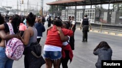 Family members of inmates react during ongoing prisoner transfers, part of a government plan to reduce overcrowding in the country's prisons, in Guayaquil, Ecuador, Nov. 1, 2022.