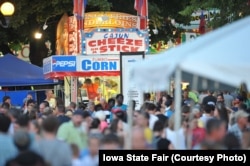 A wide view of the food stands at the Iowa State Fair features many foods "on a stick."