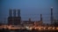 FILE - A refinery is lit up at the Jubail Industrial City, about 95 kilometers north of Dammam, in Saudi Arabia's eastern province overlooking the Gulf, Dec. 11, 2019.