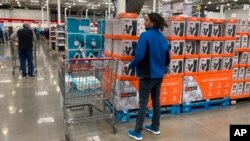 FILE - Shoppers wander the aisles of a Costco warehouse on Oct. 26, 2022, in Sheridan, Colo.