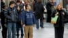Pedestrians wait to cross a New York street, March 13, 2013.