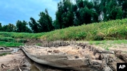 FILE - The remains of a boat lay on the banks of the Mississippi River in Baton Rouge, La., on Oct. 17, 2022, after recently being revealed because of the low water level. The pieces of the boat, which archaeologists believe are parts of a ferry that sank in the late 1800s to early 1900, were spotted by a Baton Rouge resident walking along the shore.