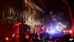 Firefighters respond to a building fire, Dec. 28, 2017, in the Bronx borough of New York. The Fire Department of New York says a blaze raging in the Bronx apartment building has left six people dead and more seriously injured.