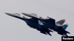 FILE - Russian air force Su-27 jet fighters perform at an air show outside Moscow in 2011. 