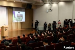 Ukrainian President Volodymyr Zelenskiy addresses South Korean parliament via video link at National Assembly in Seoul, South Korea, April 11, 2022.