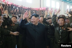 North Korean leader Kim Jong Un reacts with scientists and technicians of the DPRK Academy of Defence Science after the test-launch of the intercontinental ballistic missile Hwasong-14