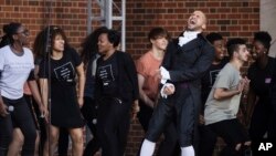 FILE - Sydney James Harcourt, an original cast member from the Broadway musical "Hamilton" performs with students from the Philadelphia High School for the Creative and Performing Arts during opening ceremonies for the Museum of the American Revolution in Philadelphia, Wednesday, April 19, 2017. (AP Photo/Matt Rourke)