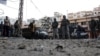 Residents and Lebanese army soldiers inspect damage following days of clashes between Sunni Muslims and Alawites in the port-city of Tripoli, northern Lebanon, December 10, 2012. 