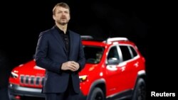 FILE - Mike Manley introduces the 2019 Jeep Cherokee at the North American International Auto Show in Detroit, Jan. 16, 2018. Manley on July 21, 2018, was named chief executive of Fiat Chrysler Automobiles.