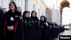 FILE - Members of the Order of the Knights of Malta arrive in St. Peter's Basilica for their 900th anniversary at the Vatican, Feb. 9, 2013. 