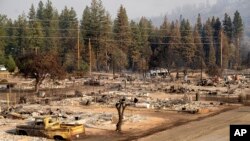 Homes destroyed by the Mill Fire line Wakefield Ave. on Saturday, Sept. 3, 2022, in Weed, Calif.