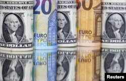 U.S. dollars and Euro banknotes are seen in this illustration taken on July 17, 2022. (Dado Ruvic/Reuters)
