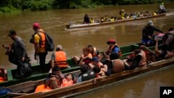 FILE - Migrants heading north arrive via boats to Lajas Blancas, Panama, June 28, 2024, after walking across the Darien Gap from Colombia. 