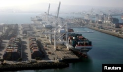 FILE - A container ship is docked at the Ports of Los Angeles and Long Beach, Calif., in this aerial photo, Feb. 6, 2015. Once the trade war sets in, shipping rates for all good will likely increase, said Stephen Cheung, president of the World Trade Center Los Angeles.