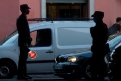 Police prepare to stop vehicles at a control point in the Vallecas district of Madrid, Spain, Oct. 9, 2020. Spain's government has declared a state of emergency in Madrid, wresting control of efforts to fight COVID-19 from local authorities.