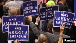 Delegates hold signs during speeches at the Republican National Convention, Cleveland, Ohio, July 18, 2016. 
