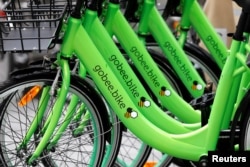 Several "Gobee.bike" bicycles, a city bike-sharing service, by Hong Kong startup Gobee.bike, are seen on a sidewalk in Paris, France, Oct. 10, 2017.