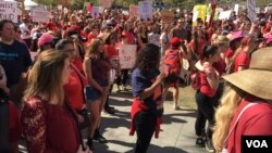 People participate in the 'Day Without a Woman' rally in front of Los Angeles City Hall, March 8, 2017. (E. Lee/VOA)