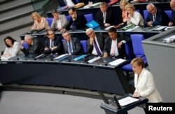 FILE - German Chancellor Angela Merkel (R) delivers a speech at the lower house of parliament Bundestag in Berlin, Germany, June 28, 2016.