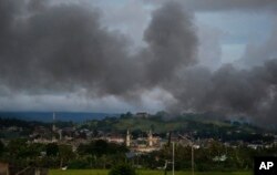 Black smoke from continuing military air strikes rises above a mosque in Marawi city, southern Philippines, June 9, 2017.