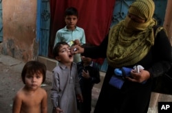 FILE - A Pakistani health worker gives a polio vaccine to a child in Karachi, Pakistan, Dec. 1, 2016. Polio remains endemic in Pakistan after the Taliban banned vaccinations.
