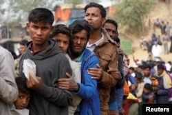 FILE - Rohingya refugees line up for daily essentials distribution at Balukhali camp, near Cox's Bazar, Bangladesh, Jan. 15, 2018.