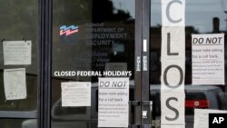 Information signs are posted at the Illinois Department of Employment Security Friday, June 5, 2020, in Chicago. The federal unemployment rate declined to 13.3 percent in May from 14.7 percent in April with a gain of 2.5 million jobs. (AP Photo/Nam…