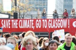 People take part in a Climate March in Brussels, Belgium, ahead of the COP26 climate summit in Glasgow on October 10, 2021. (Yves Herman/Reuters)