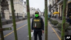 A police officer stands guard one block away from the Constitutional Court building in Lima, Peru, Sept. 17, 2020. 