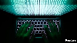 A man uses a computer keyboard to enter data in Warsaw, Poland.