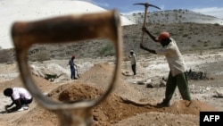 FILE - Workers try to start up an old metals mine in Uis, Namibia. Mining is the biggest contributor to Namibia’s gross domestic product.