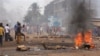 Anti government protesters burn tires and place rocks in the streets in Conakry, Guinea, May 3, 2013
