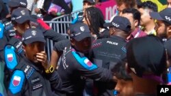 In this image from video, Qatari police try to control a crowd at a FIFA Fan Zone ahead of the World Cup in Doha, Qatar, Nov. 19, 2022.