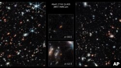 This image made available by the Space Telescope Science Institute on Thursday, Nov. 17, 2022, shows two of the farthest galaxies seen to date captured by the James Webb Space Telescope. (NASA, ESA, CSA, Tommaso Treu (UCLA), Zolt G. Levay (STScI) via AP)