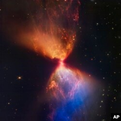 This image made available by the Space Telescope Science Institute on Wednesday, Nov. 16, 2022, shows a protostar within the dark cloud L1527 embedded within a cloud of material feeding its growth, captured by the James Webb Space Telescope. (NASA, ESA, CSA, STScI, Joseph DePasquale (STScI), Alyssa Pagan (STScI), Anton M. Koekemoer (STScI) via AP)