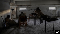 A Ukrainian sniper unit takes aim at Russian positions in the Kherson region, southern Ukraine, Nov. 19, 2022.