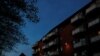 FILE - Night falls over Mjolnerparken, a housing estate for migrants that features on the Danish government's "Ghetto List," in Copenhagen, Denmark, May 2, 2018.