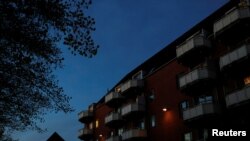 FILE - Night falls over Mjolnerparken, a housing estate for migrants that features on the Danish government's "Ghetto List," in Copenhagen, Denmark, May 2, 2018.