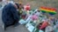 A man prays at a makeshift tribute with a display of bouquets of flowers on Nov. 21, 2022, a day after a shooting at the LGBT nightclub Club Q in Colorado Springs, Colo. 