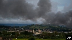 Black smoke from continuing military air strikes rises above a mosque in Marawi city, southern Philippines, June 9, 2017.