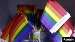 FILE - Rainbow flags are seen at social research institute during a meeting of gays in Hanoi, Vietnam, Nov. 26, 2015.