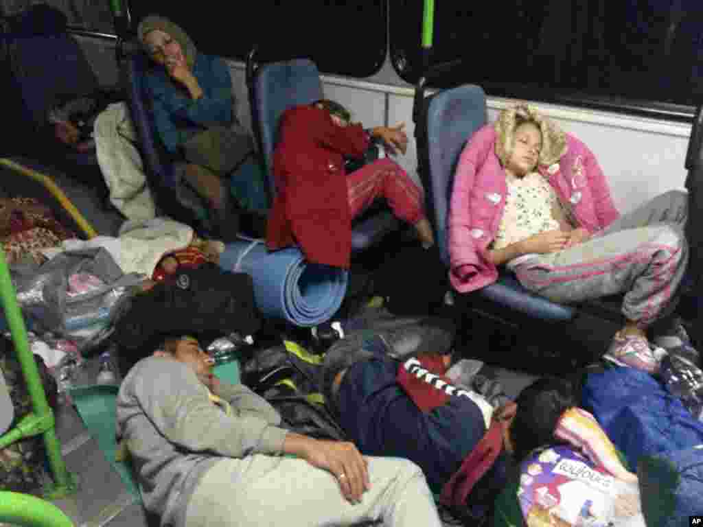 Migrants sit in a bus from Budapest to the Austrian border near Gyor, Hungary, Sept. 5, 2015. 