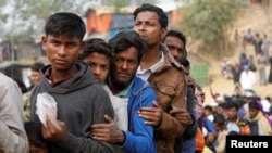 FILE - Rohingya refugees line up for a daily essentials distribution at Balukhali camp, near Cox's Bazar, Bangladesh, Jan. 15, 2018. 