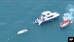 An aerial view shows two rescue vessels alongside a capsized boat Saturday, off Kaikoura, New Zealand, Sept. 10, 2022.