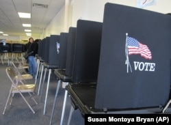 In this Oct. 26, 2012, photo, members of the Native American Voters Alliance mark ballots at an early voting center in Albuquerque, N.M.