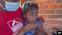 FILE - A child receives a measles vaccination at a clinic in Harare, Zimbabwe, Sept. 6, 2022.