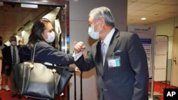 In this photo released by the Taiwan Ministry of Foreign Affairs, Taiwan Deputy Minister of Foreign Affairs Tien Chung-kwang, right, bumps elbow with US Rep. Stephanie Murphy at Taoyuan airport near Taipei, Sep. 7, 2022. 