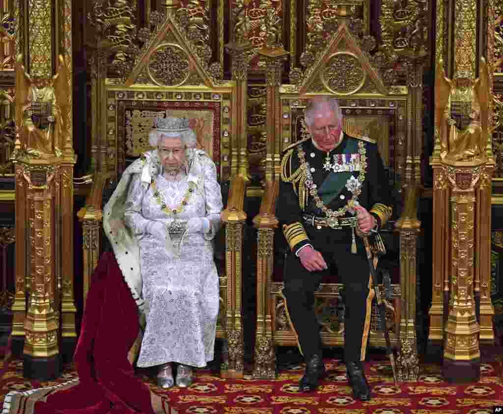 Queen Elizabeth II, with Prince Charles, delivers the Queen's Speech at the official State Opening of Parliament in London, Oct. 14, 2019.