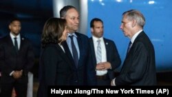 Vice President Kamala Harris, left, and her husband Doug Emhoff, center, are greeted by Robert Godec, U.S. Ambassador to Thailand, upon arrival at Don Mueang International Airport in Bangkok, Thailand, on Nov. 17, 2022, to attend the Asia-Pacific Economic Cooperation summit.